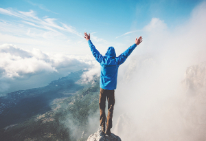 A man on the top of a mountain