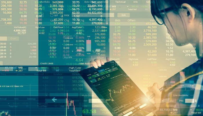 woman on a tablet checking stock market graph