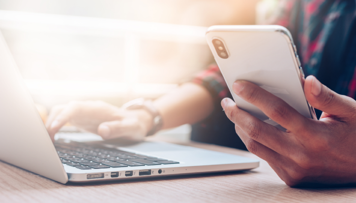 Broker using laptop and phone