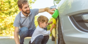father and son washing car
