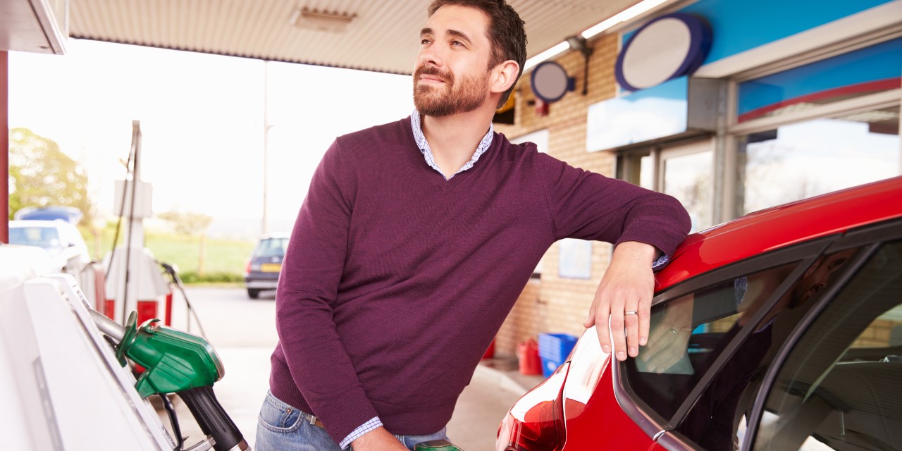 man filling car with petrol