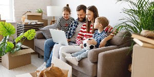 family at home unpacking boxes