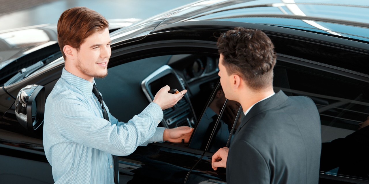 two men selling a car