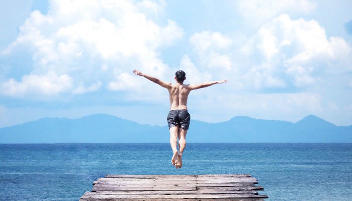 man jumping into the sea