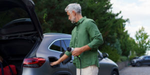Man holding power cable at ev charging station