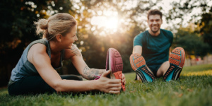 active couple stretching in park
