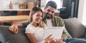 young couple at home on tablet