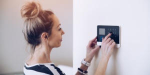 woman setting home alarm