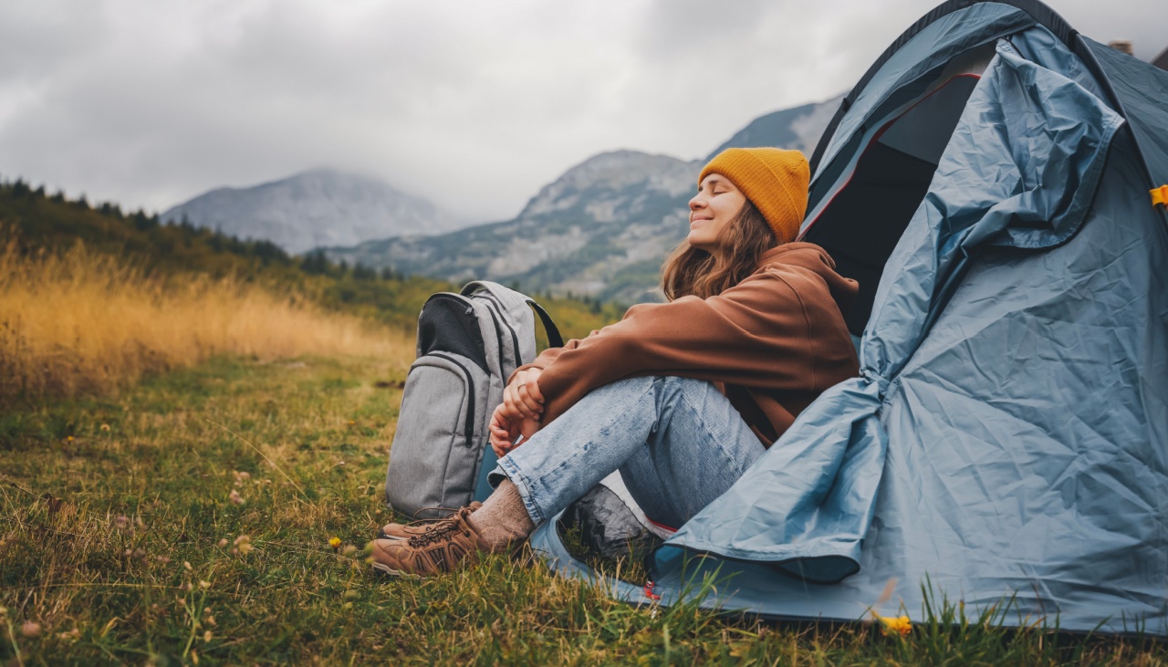 Woman camping in blue tent