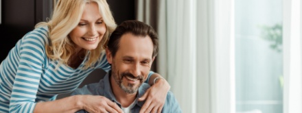 happy couple at home on laptop