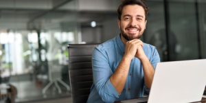man at office desk with laptop