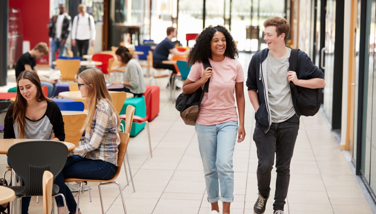 Two college students walking in common areas