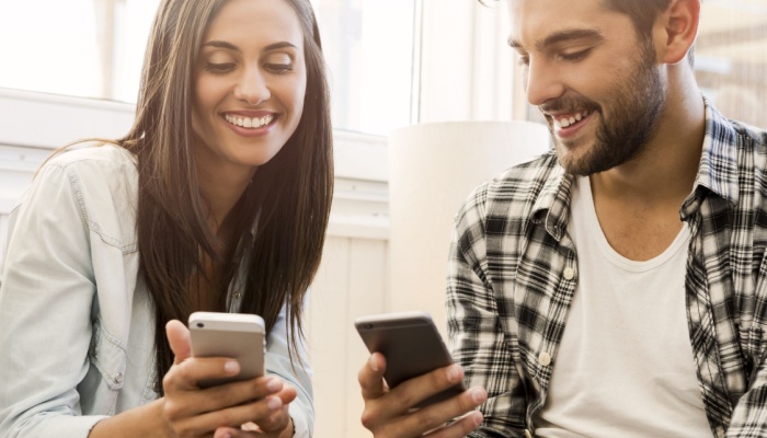 friends in coffee shop on phone
