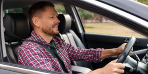 man driving car