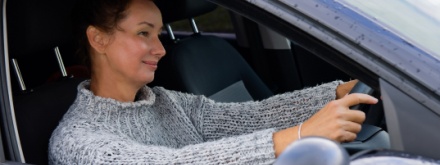 smiling woman driving car