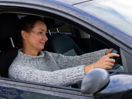 smiling woman driving car