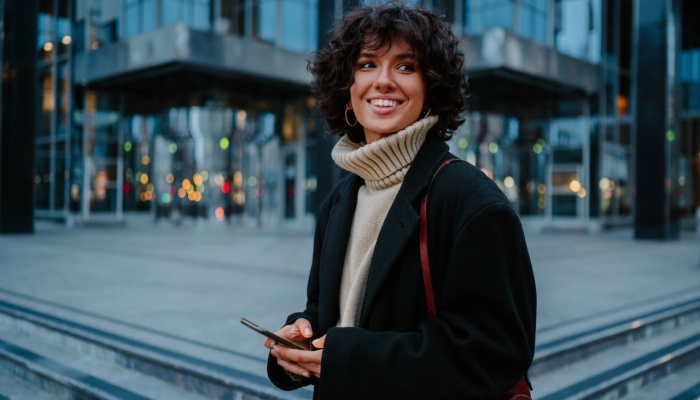 smiling woman in the city on phone