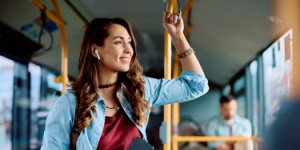 woman on public transport listening to music