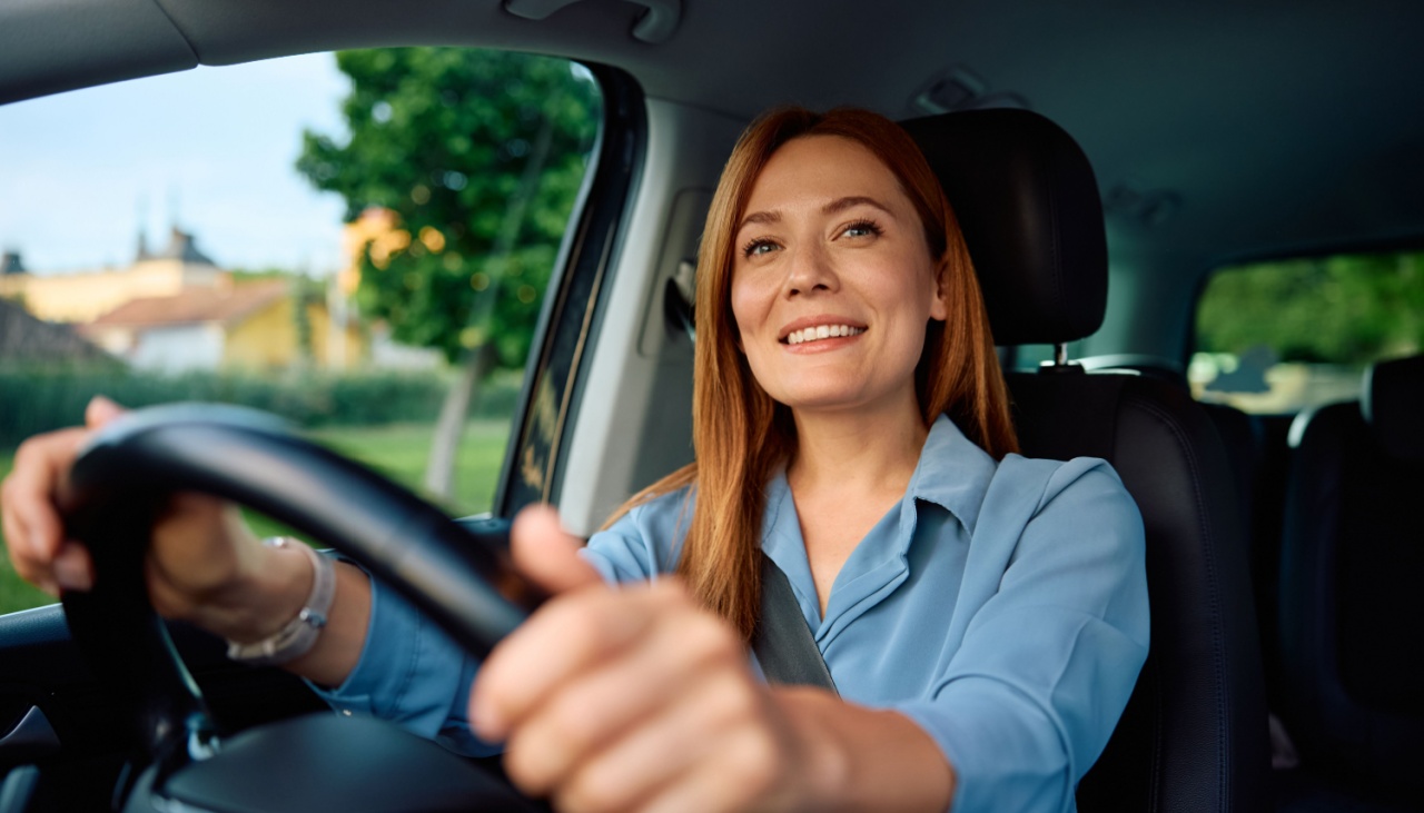 smiling woman driving car