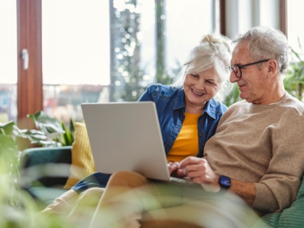 senior couple at home on laptop