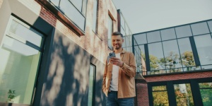 man outside looking at phone