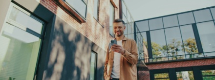 man outside looking at phone