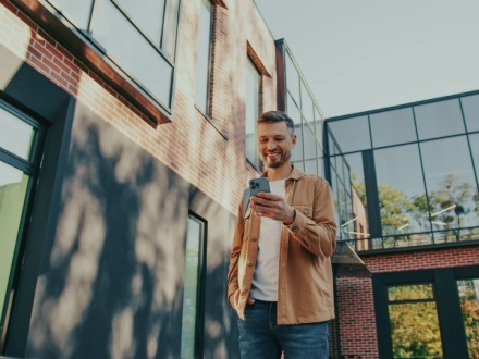 man outside looking at phone