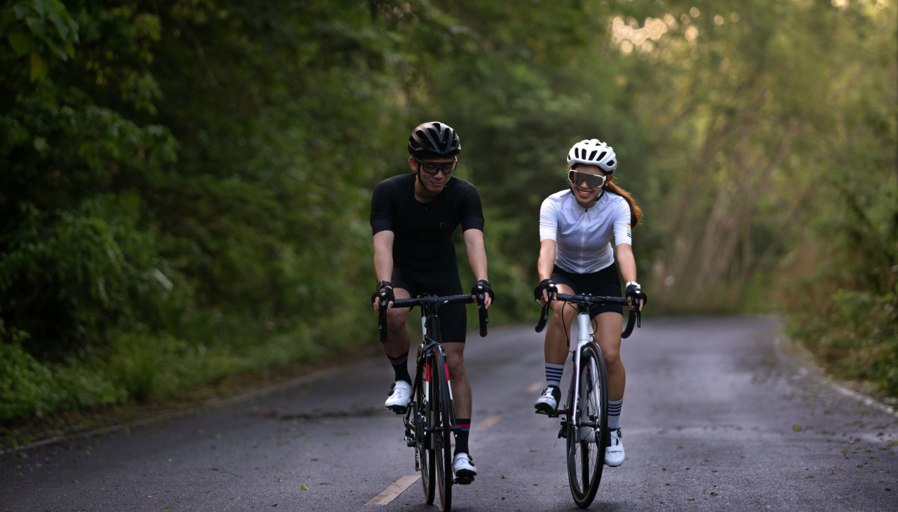 man and woman road cycling