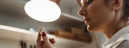 young female jeweler inspecting a ring
