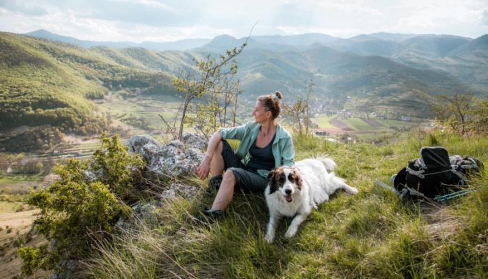 woman in the countryside with her dog