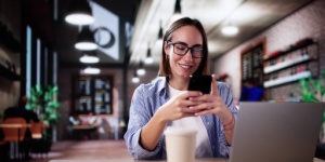 student in coffee shop on phone