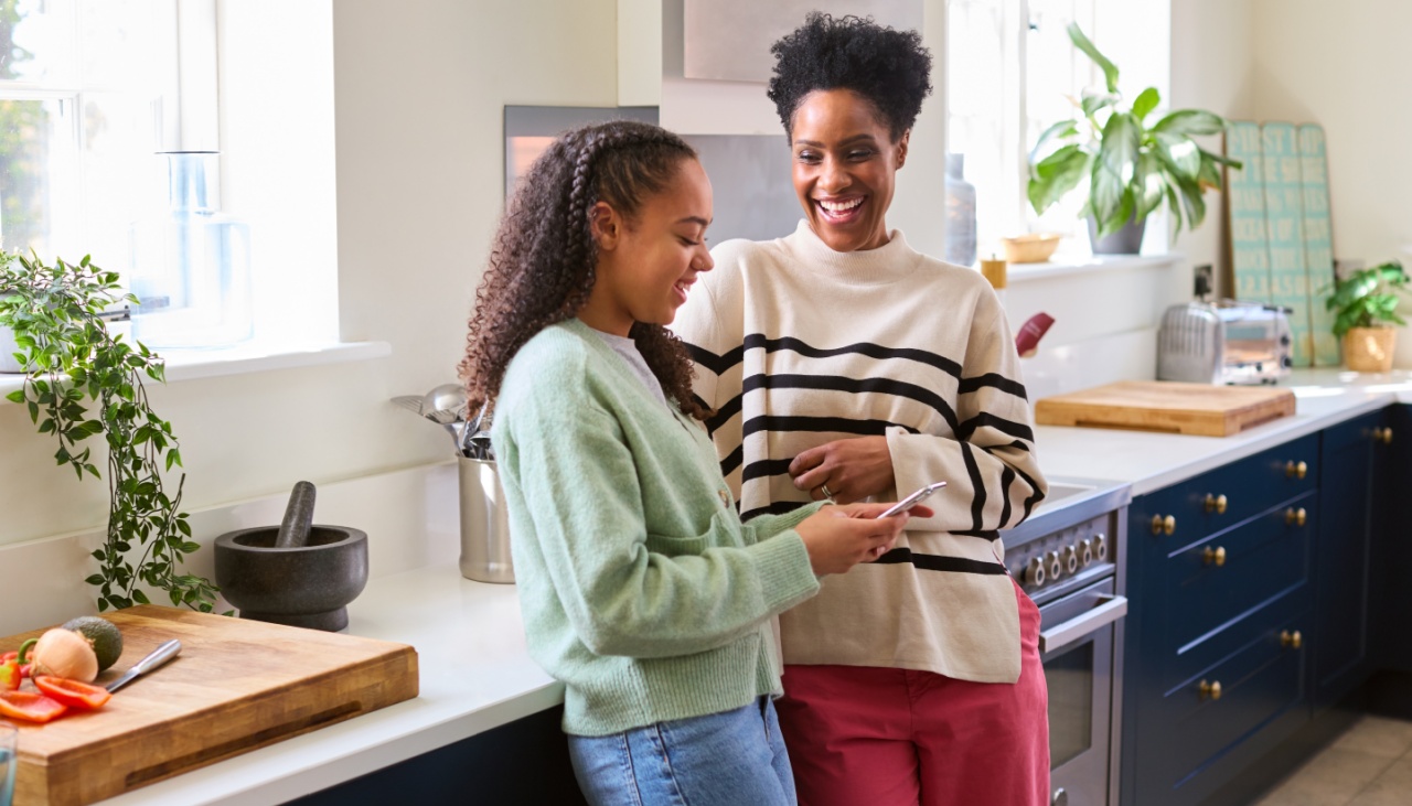 Mother and daughter in kitchen chatting