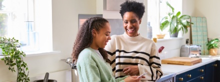 Mother and daughter in kitchen chatting
