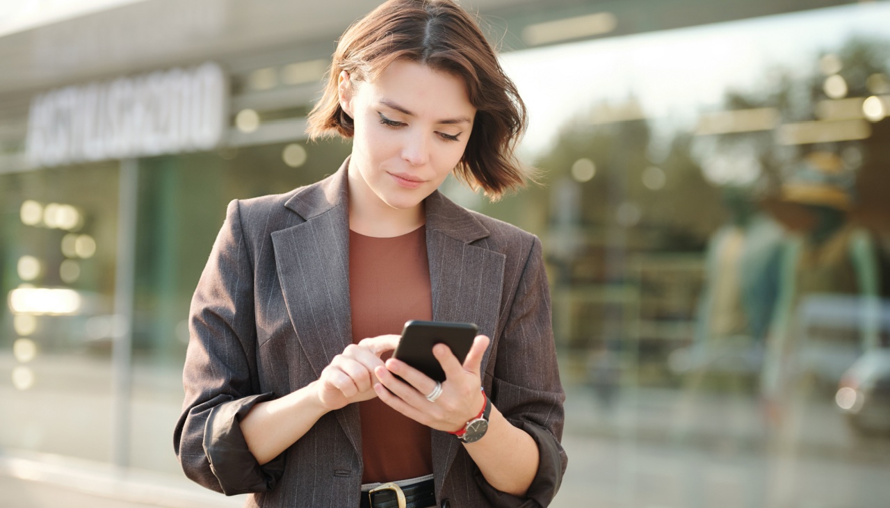 young business woman typing on her phone