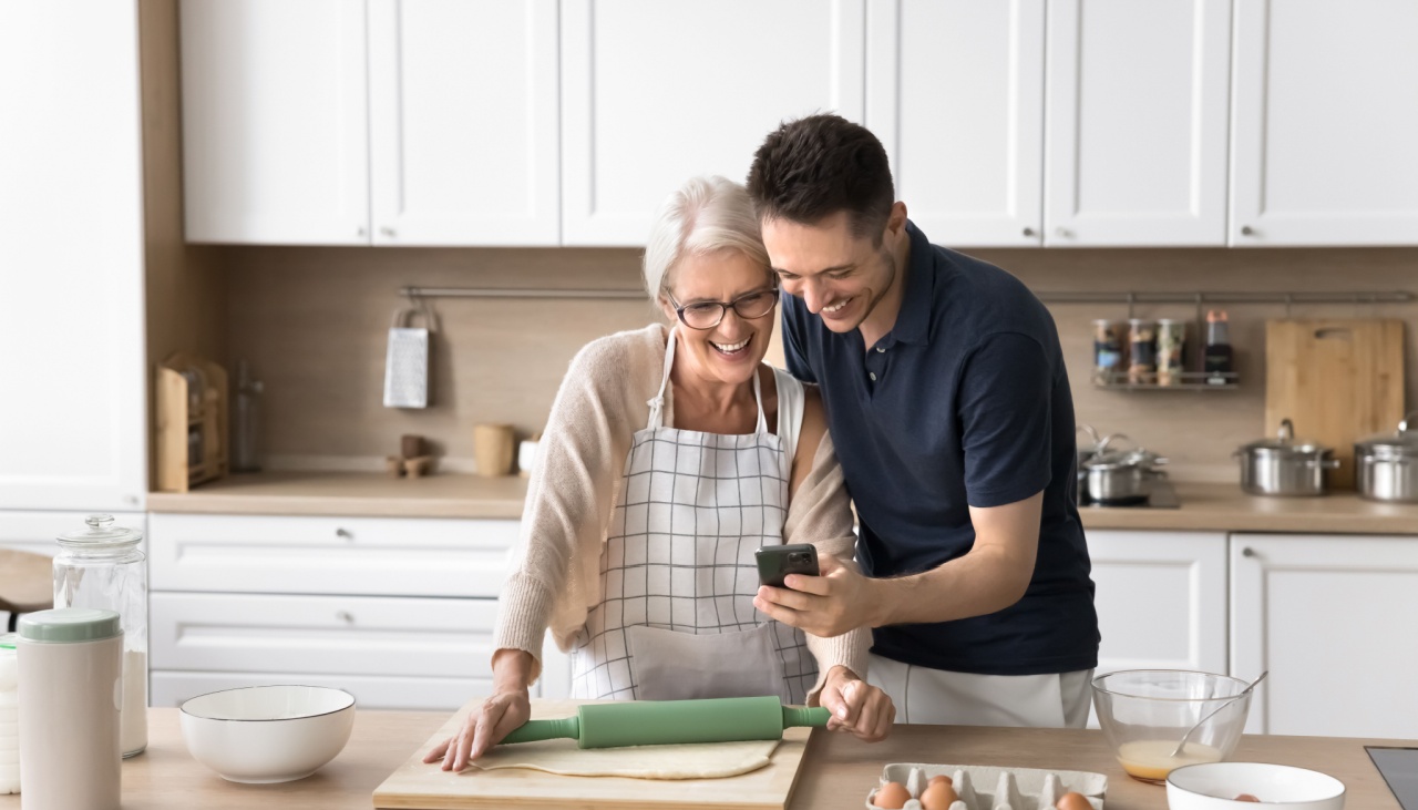 Grown up son spend time with mother in kitchen
