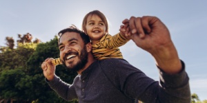 father with child on his shoulders