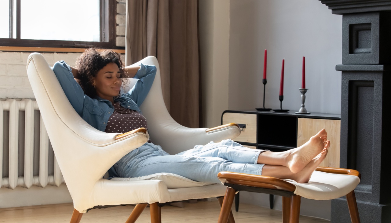 African woman at home relaxing in chair