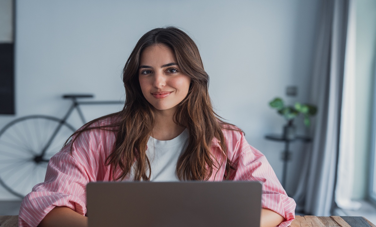 Young woman sitting at home office desk