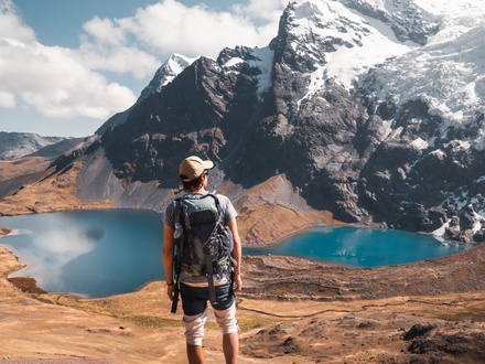 Male hiker enjoying views of mountains and lakes