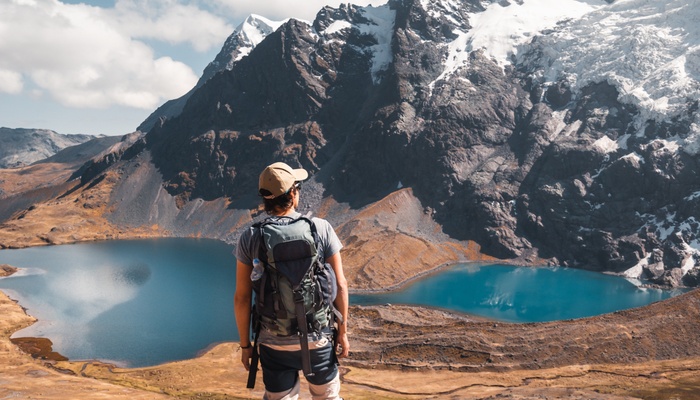 Male hiker enjoying views of mountains and lakes