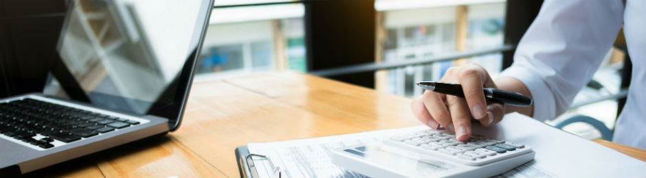 a woman at a desk using a calculator