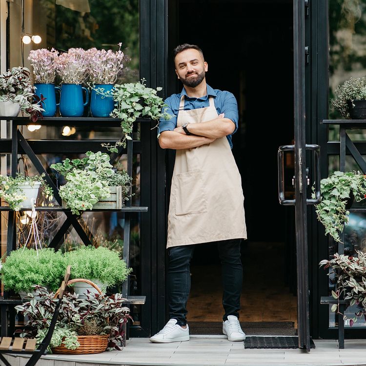 Gardener standing next to his plants