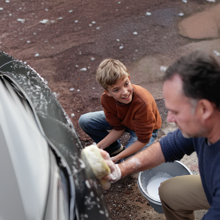 Father and son washing car