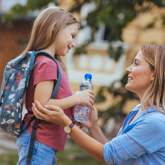 mother bring young daughter to school
